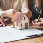 A Home Buyer and loan officer going over loan paperwork in a corporate office for home purchase